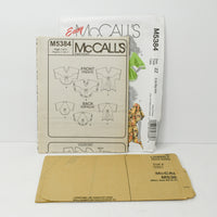 McCall's M5384 paper instruction sheets and uncut tissue paper sewing pattern.