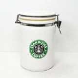 Shown is a vintage white ceramic 8 inch Starbucks canister. circa 1990's.