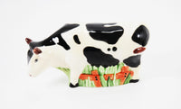 A close up view of the vintage standing cow shaker.
