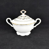 Shown is a white and gold vintage fine china covered sugar bowl. It is shown on a black background. It was produced by Seltmann Weiden, Germany.