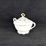 Another view of the vintage Seltmann fine china covered sugar bowl. It is white with gold trim accents. It was photographed on a black background.