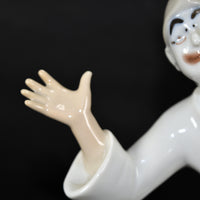 A close up of The White Clown's right hand and arm.