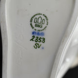 A close up of the backstamp of The White Clown. The initials ES & SJ are embossed to the left of the backstamp.