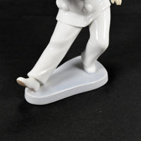 A close up of The White Clown's feet, legs and base.