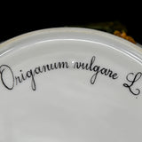 Origanum vulgare L. is written in cursive and is black in color. The underside is white porcelain and is shiny.