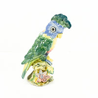 Shown is a beautiful example of one of the birds from Stangl pottery. This is their cockatoo #3580 which was probably produced from 1940-1950's. The cockatoo is painted with wonderful greens, blues, reds and yellow. It is perched on a branch which has floral detail on it.