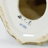 A closer view of the initials D.C.F and the number 3580. Some wear can be seen on the base underside also.