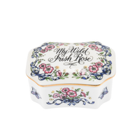 Shown is a vintage Franklin Mint porcelain music box. It is decorated in Irish pink roses and butterflies on each corner. The song title is painted on the lid. The lid is trimmed in gold paint. The lid lifts off and the turn key for the music box is inside the base.