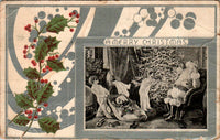 This is a full view of the antique Christmas postcard. On the left there is a sprig of green holly and red berries. The rest of the postcard has a silver and white decoration.