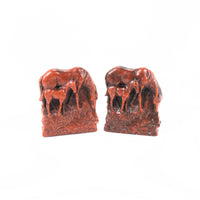 Shown is a pair of vintage Syroco bookends featuring a mare and her foal. The horses are facing to the right. The color is a reddish brown.