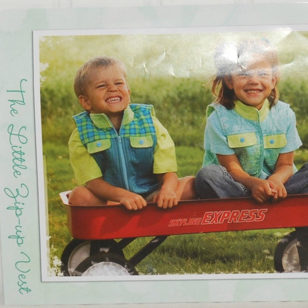 Shown is a partial view of the insert for Favorite Little Things Zip-Up pattern L003. It shows a color photograph of a little smiling boy and girl wearing vests that can be made with this pattern. They are both sitting in s red Skyline Express wagon.