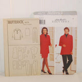 The paper instruction sheet for c. 1996 Butterick 4679 is propped up in front of the paper envelope and to the left of the envelope..