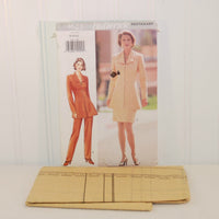 The factory folded tissue paper sewing pattern for Butterick 3623 is laying down in front of the paper envelope.