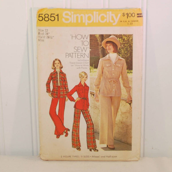 Shown is the front of the envelope for vintage Simplicity 5851, c. 1973. It has two illustrated women on the left and center, both wearing red and red plaid outfits. There is a color photo of a woman wearing a beige hat and outfit.