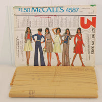 The factory folded tissue paper sewing pattern is shown laying in front of the paper envelope for McCall's 4587.