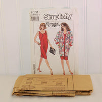The factory folded tissue paper sewing pattern is laying in front of the paper envelope for Simplicity 9081.