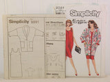 Shown are the paper instruction sheets from Simplicity 9081. There are four pages and two sheets. The sheets are slightly in front of the paper envelope and to the left.
