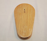 The back of the vintage wood knife holder. There is a slot on the back so that you can hang it on the wall. It is shown on a white background.