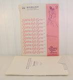 Shown is the sewing pattern for Stretch & Sew 1050. It is laying in front of the paper envelope and is unused, uncut.