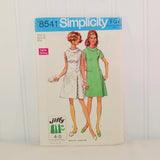 The front of the paper envelope for Simplicity 8541 circa 1969. There is an illustration of two women in above knee dresses. One dress is white and sleeveless and the other one is a light green color with a rounded collar.