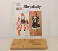 The tissue paper sewing pattern is shown laying in front of the paper envelope for Simplicity 7078. The sewing pattern is factory folded and unused.