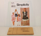 The tissue paper sewing pattern is shown laying in front of the paper envelope for Simplicity 7078. The sewing pattern is factory folded and unused.