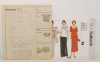 Shown are the paper instruction sheets for Butterick 6413. There are two sheets and three instruction pages. It is propped up in front of the paper envelope.