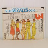 Shown is the front of the paper envelope for McCall's 6016 for Misses' sizes 16, 18 and 20. It features five illustrated women, four white and one a person of color. They are all in different poses wearing various pieces of clothing that can be made with this vintage sewing pattern. This pattern is for Stretch knits only according to the front wording.