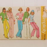 Shown is the front of the paper envelope for Simplicity 5587. It was produced circa 1973. It is for size 12, with a bust size of 34 inches and waist size of 26 1/2 inches. There is a tear on the upper right corner of the envelope. There are five white illustrated women on the front wearing a variety of clothing that can be made with this vintage sewing pattern.