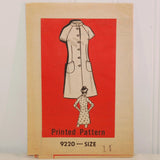 Photo shows an illustrated dress with slant pockets and a button front. There is also a smaller illustrated woman with her hair in a bun and with her back to the camera, so to speak. She has a 3/4 sleeve dress on that has a small print on it. The slightly yellowed paper states Printed Pattern 9220 Size 11. The dress and woman are printed on a red inset.