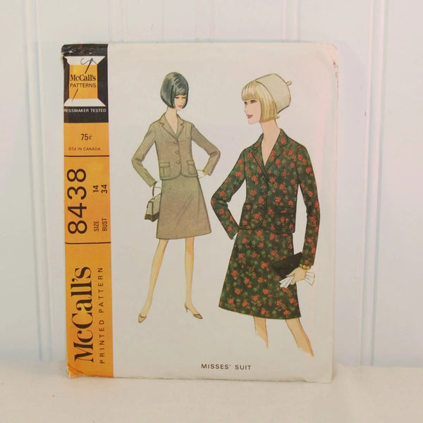 The front of McCall's 8438 misses' suit pattern envelope. There are two illustrated women on the front in a blazer and skirt combinations. The pattern is from circa 1966 and is for size 14 with a bust size of 34 inches.