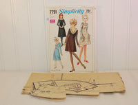 The partially cut tissue paper pattern is laying in front of the envelope for Simplicity 7791.