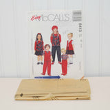 Shown is the factory folded tissue paper sewing pattern. It is laying in front of the paper envelope for McCall's 8413.