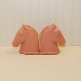 This is the side view of the two Abingdon pottery horse head bookends. They are sitting on a white background.