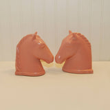 The two Abingdon pottery bookends are nose to nose in this photo to give you another side view. They are on a white background.