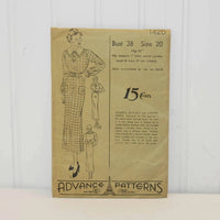 The photo depicts the front of the vintage Advanced Patterns 1420. The envelope is a light tan color with some slight fading around the edges. There is a drawing of a woman in a dress. Bust size 38 Size 20 Hip 41 inches. The pattern originally cost 15 cents in 1933.