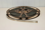Side view of the vintage Goldberg Brothers Relflex Brown metal 10 1/2 inch movie reel.