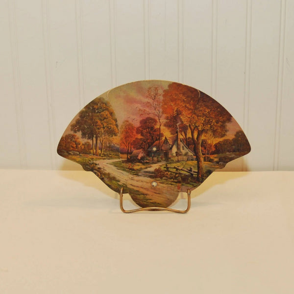 Shown is a paper advertising tri-fold fan by the U.O. Colson company from Paris, Illinois. It dates from 1928-1930's. The image on the fan is one of a cottage, a country road, trees and a fading sunset.
