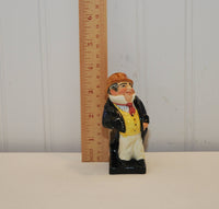 There is a wood ruler standing to the left of Captain Cuttle. It shows that he is approximately 3 3/4 inches tall.