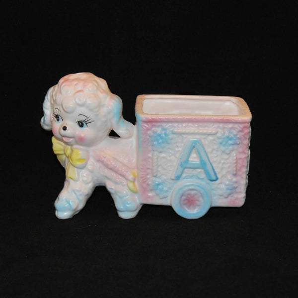 Featured is vintage Relpo Ceramic lamb pulling an ABC cart planter. It was produced circa 1950-50's. It was made in Japan. The colors are soft pastels of pink, blue and yellow on white.