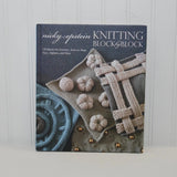 Featured is the front cover of the hardcover book, Knitting Block by Block by Nicky Epstein.