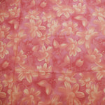 This beautiful floral cotton fabric has soft shades of pink and flowers in a random pattern. The fabric was produced circa 2005.