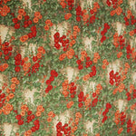A photo of this wonderful cotton fabric that appears to be hollyhocks. The hollyhocks are red and orange on stalks of green. The background is a cream color with hints of tan.