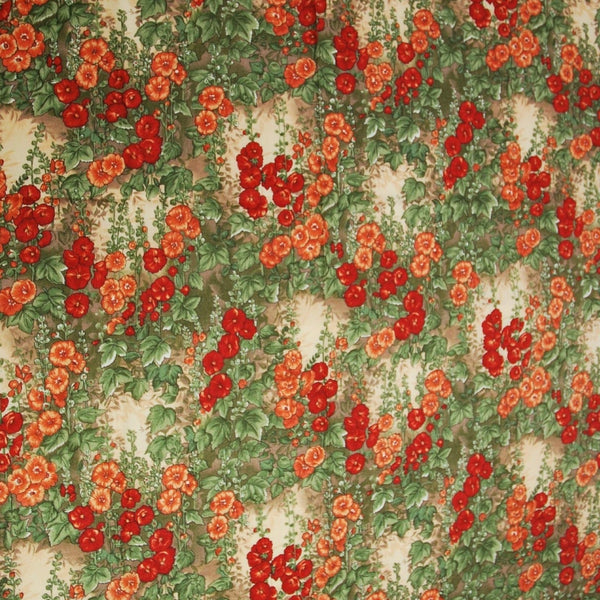 A photo of this wonderful cotton fabric that appears to be hollyhocks. The hollyhocks are red and orange on stalks of green. The background is a cream color with hints of tan.