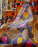A page from the book that shows a photo of a beautiful quilts draped over a wood rocking chair.