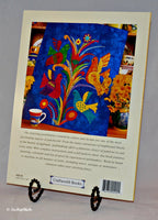 The back cover of the Bright and Beautiful Quilts, featuring a very colorful quilt that has a bright blue background, colorful birds on colorful branches.