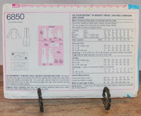 The back of Simplicity 6850 is shown in this photo. It is on a small metal stand.