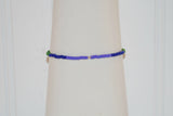This photo shows the back of the Pride bracelet. There are green, then blue and then purple seed beads. There is a small silver metal crimp in between the purple beads. 
