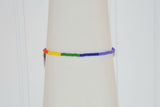A side view of the Pride bracelet handcrafted by Too Hip Chicks. Orange, yellow, green, blue and purple seed beads can be seen.