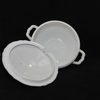 The underside of the lid can be seen, as well as the interior of the soup tureen. Both are a solid creamy white color. There is a inner rim on the lid to help keep it in place.